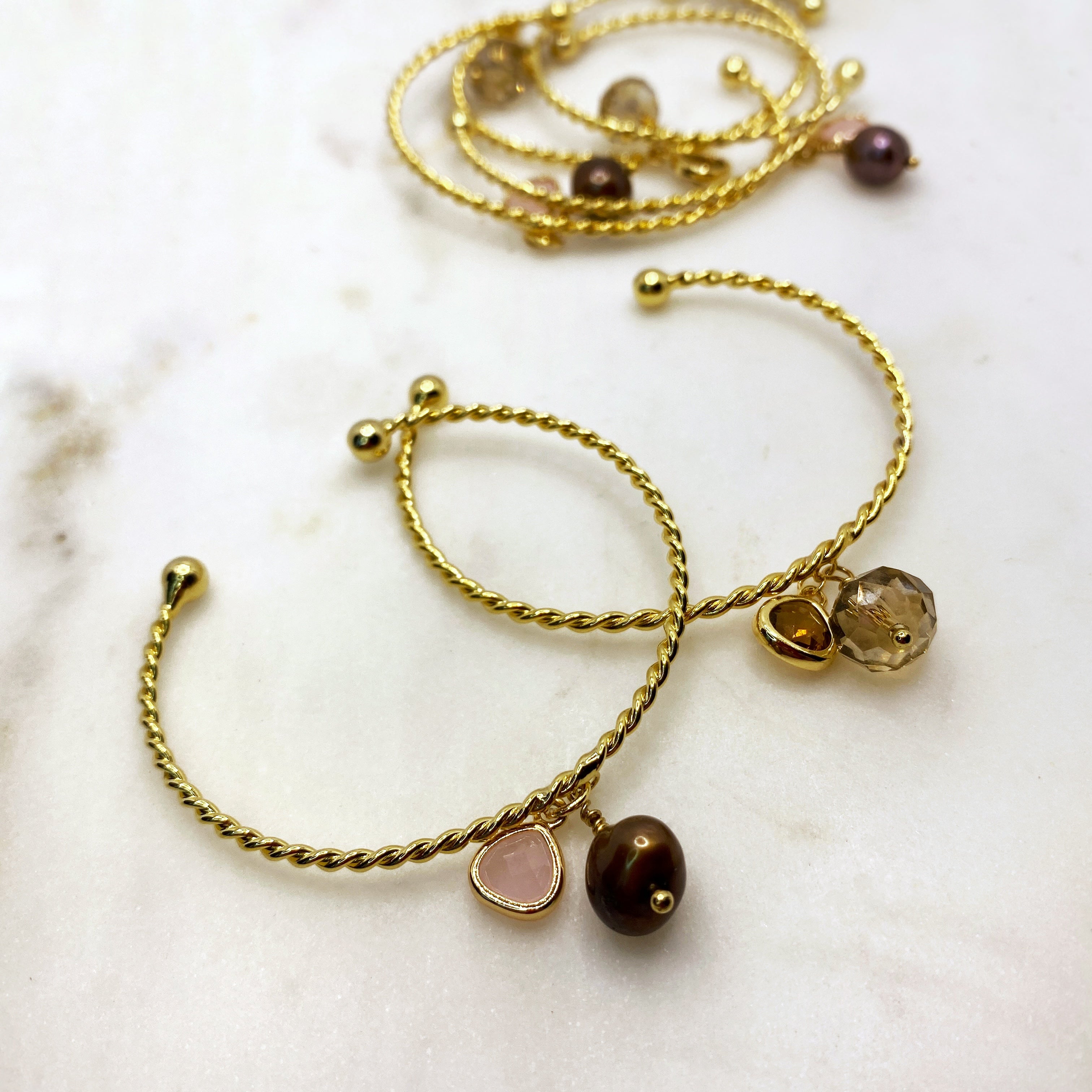 Gold spiral cuff with dainty charms