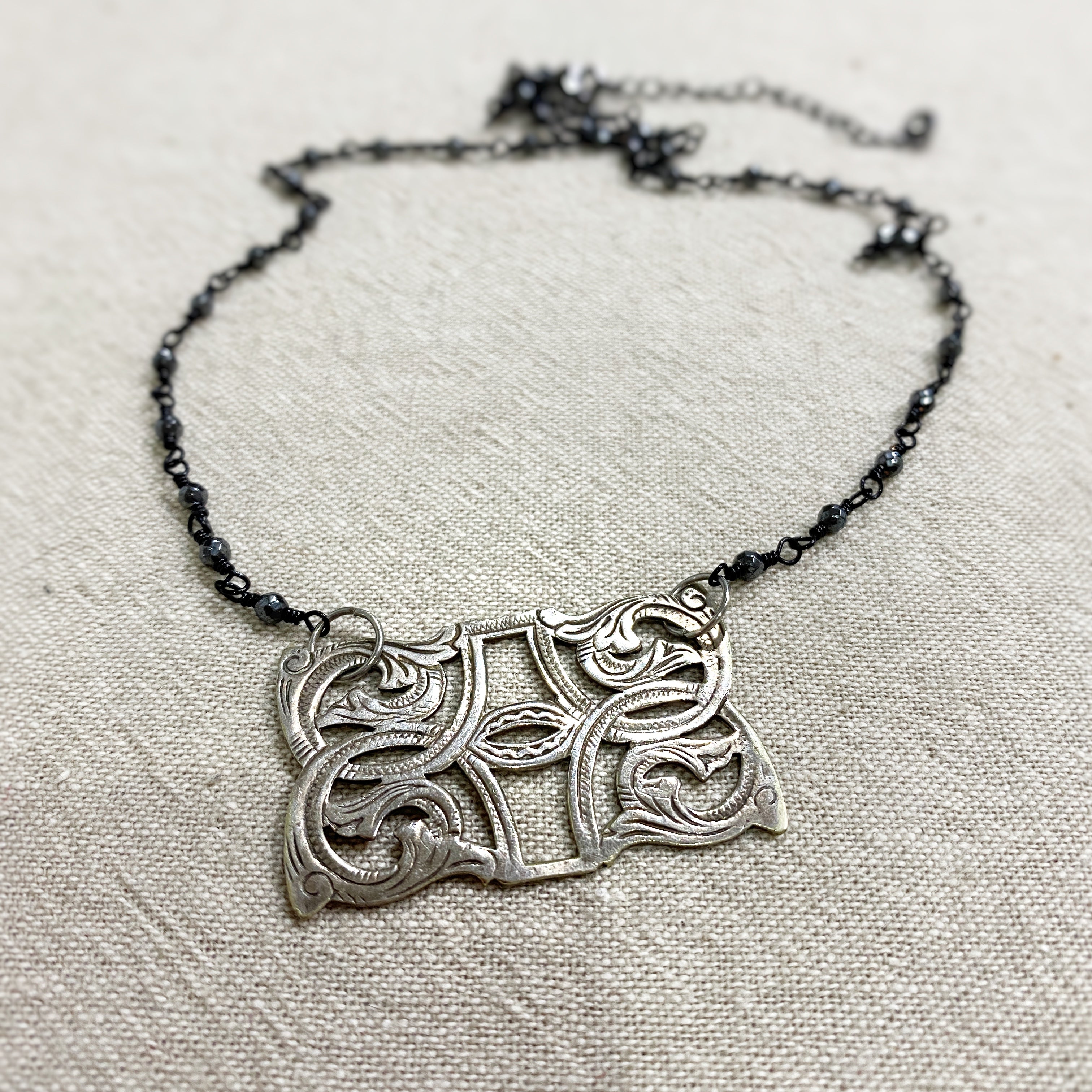 Tribal Mine Flourish Necklace - silver pendant on black rosary chain